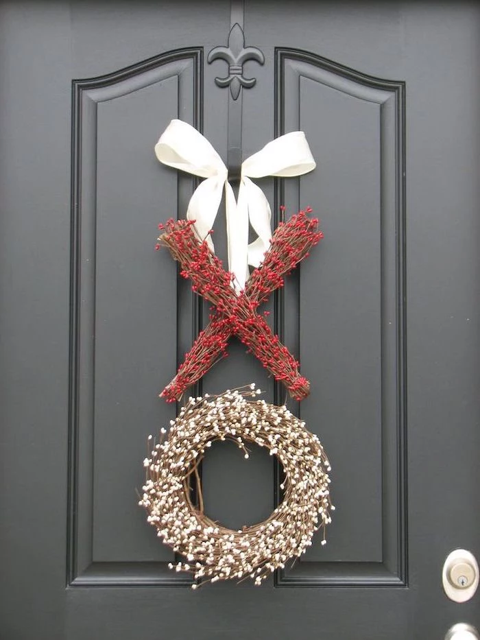 xo garlands and wreaths made with twigs and faux berries, hanging with white satin bow on black door, valentines decoration ideas