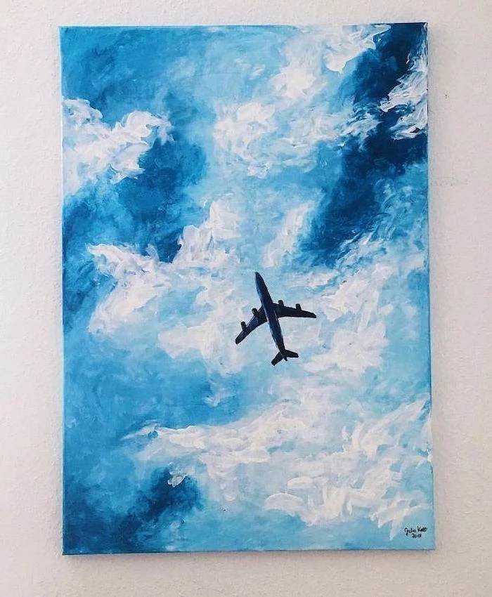 blue and white clouds, painting ideas for beginners, airplane flying in the sky, painting hanging on white wall