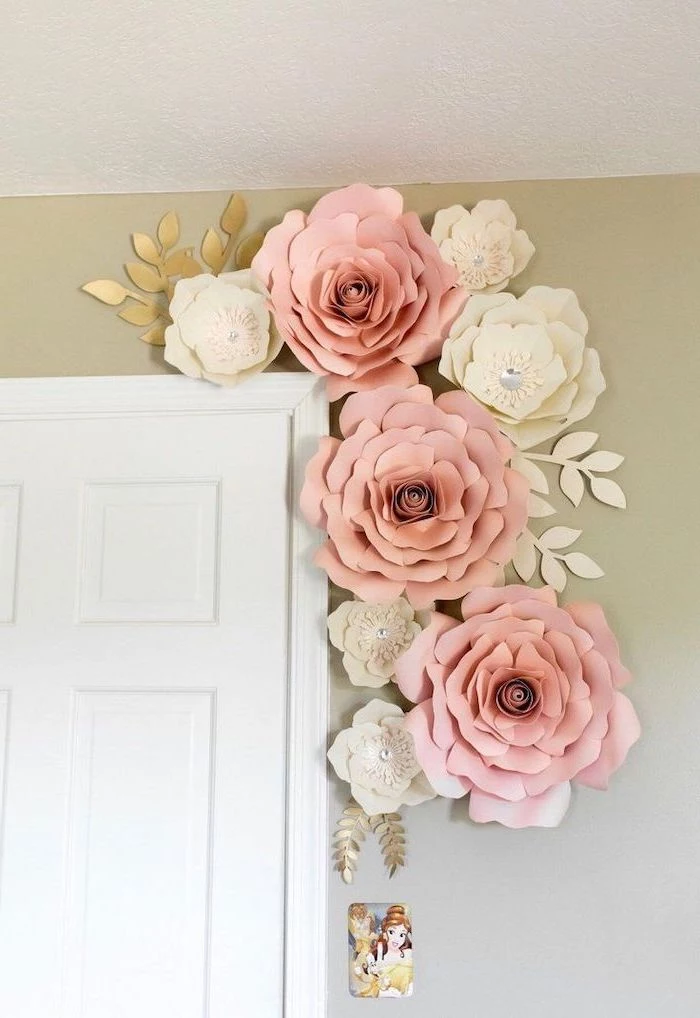 large blush and white paper flowers, arranged together over a white door, how to make tissue paper flowers
