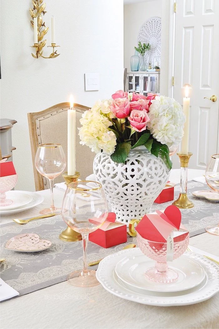 dinner table with flower bouquet in the middle, valentines decoration ideas, glasses with pink carton boxes inside