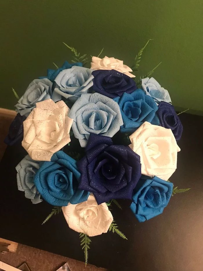 how to make tissue paper flowers, blue and white small paper roses, made of crepe paper, arranged in a bouquet