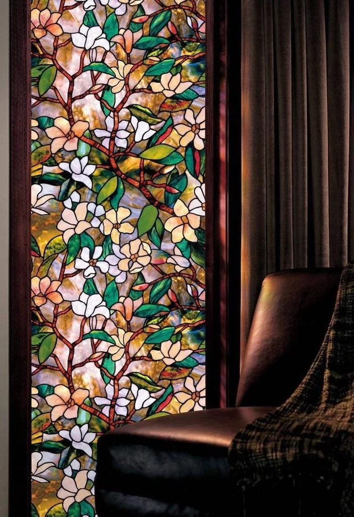 brown leather sofa with throw blanket, how to make stained glass, next to a window decorated with flowers