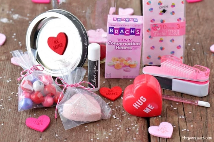 conversation hearts and lip balm, candy and nail kit, placed on wooden surface, valentines day gifts, step by step diy tutorial