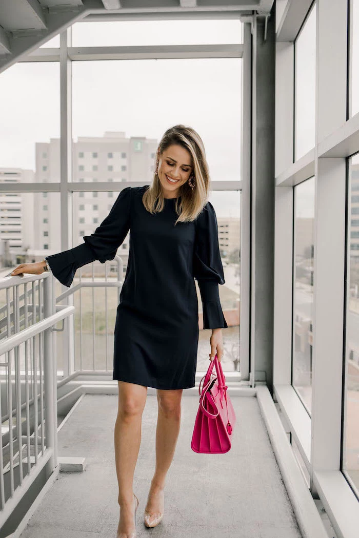 woman wearing black dress with long sleeves, pink leather bag, nude shoes, red dress for valentine's day