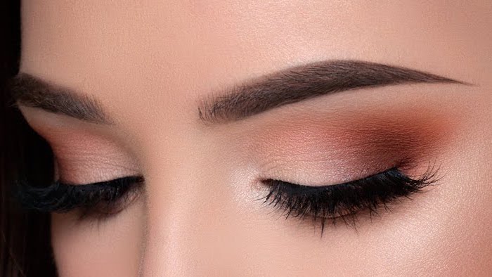 white orange eyeshadow colors, woman with thick dark eyebrows, eyeshadow tutorial, long black lashes