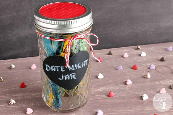date night jar, mason jar filled with ideas for dates, written on popsicle sticks, valentines day gifts, placed on wooden surface