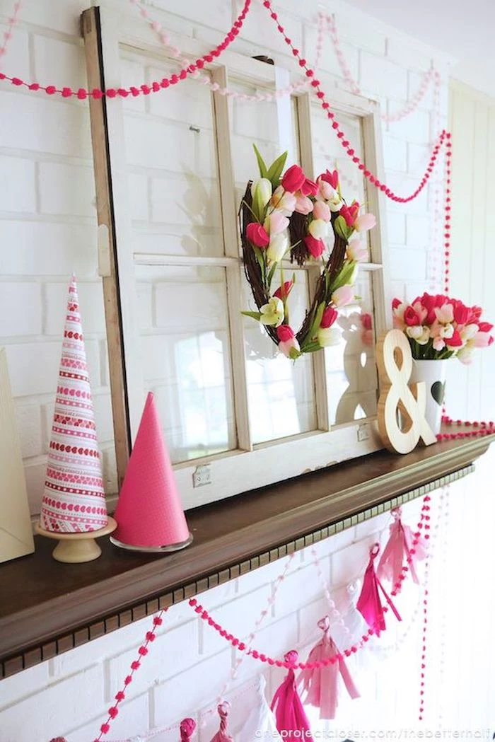heart shaped wreath made with tulips, valentine's day decoration ideas, pink garlands hanging over white mantel