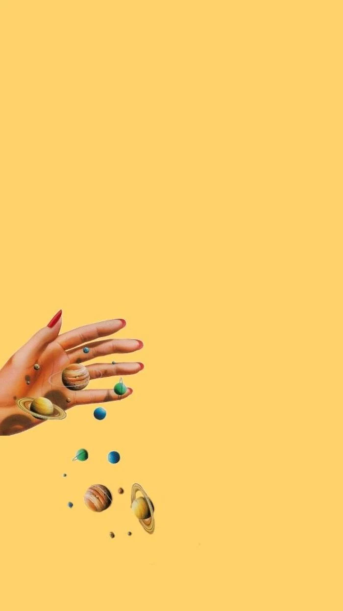 female hand with red nail polish, holding planets on yellow background, cute aesthetic wallpapers
