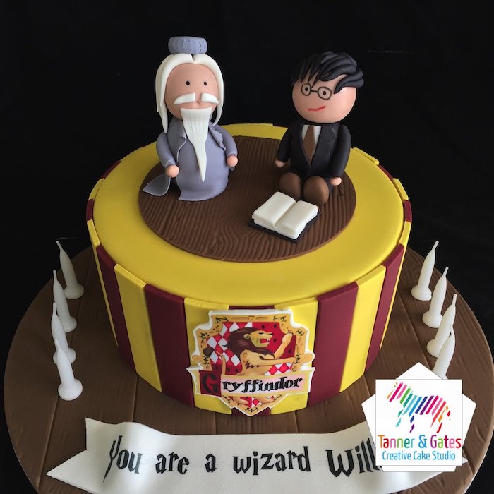 dumbledore and harry toppers made of fondant, harry potter cake hagrid, one tier cake with red and yellow fondant