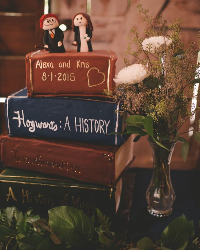 cake with each layer in the shape of a book, hagrid birthday cake, hogwarts a history, a history of magic and transfiguration textbooks