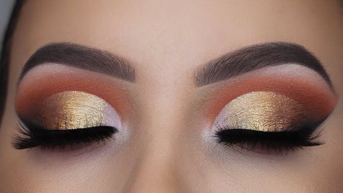 golden orange eyeshadow colors, green eyeshadow, woman with dark thick eyebrows, black cat eyeliner