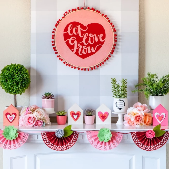 decorations made of paper, valentines day decor, let love grow wreath, hanging over a mantel, potted succulents arranged on top
