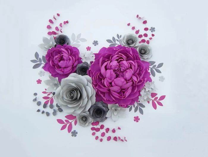 purple and grey paper flowers, different shapes and sizes, giant paper flowers, arranged on a white surface