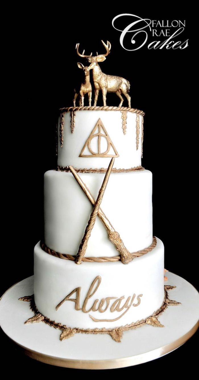 three tier cake, covered with white fondant and gold decorations, stag and deer patronus toppers, hagrid cake