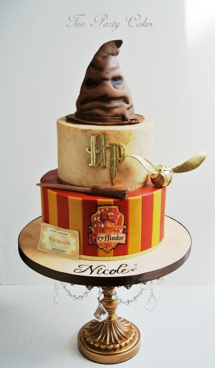 two tier gryffindor cake, made with red and yellow fondant, happy birthday harry potter cake, sorting hat and golden snitch toppers