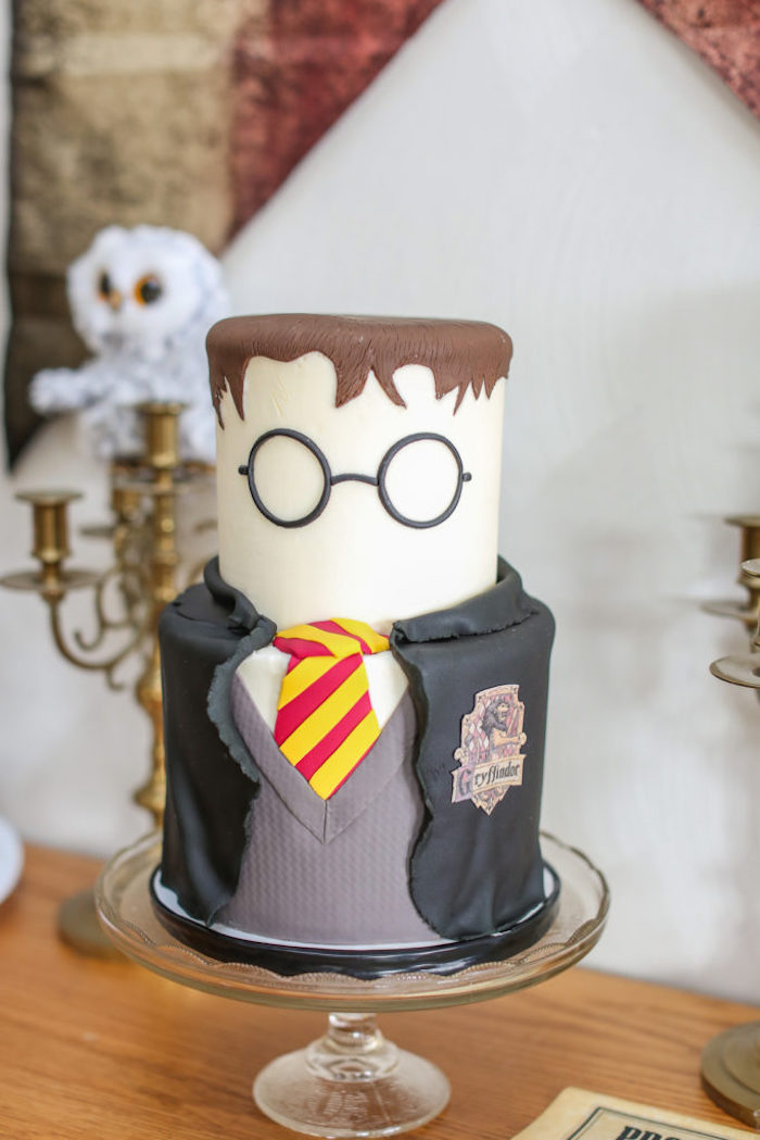 happy birthday harry potter cake, two tier cake, harry with gryffindor uniform, placed on glass cake stand