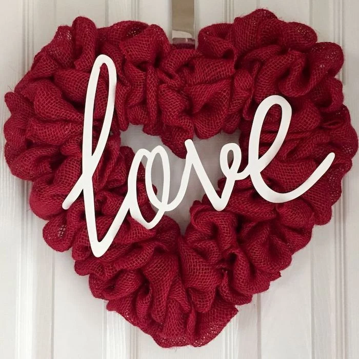 diy valentine decorations, heart shaped wreath, made of fabric, white love letters in the middle, hanging on white door