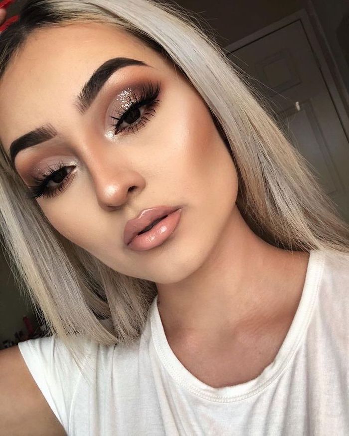 how to do eyeshadow, blonde woman with thick dark eyebrows, silver glitter eyeshadow colors, nude lipstick