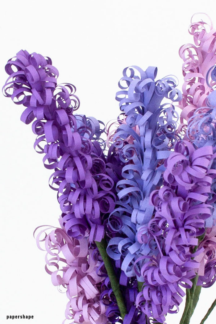 hyacinth flowers made of paper, how to make paper flowers, arranged in a bouquet, purple pink and blue paper