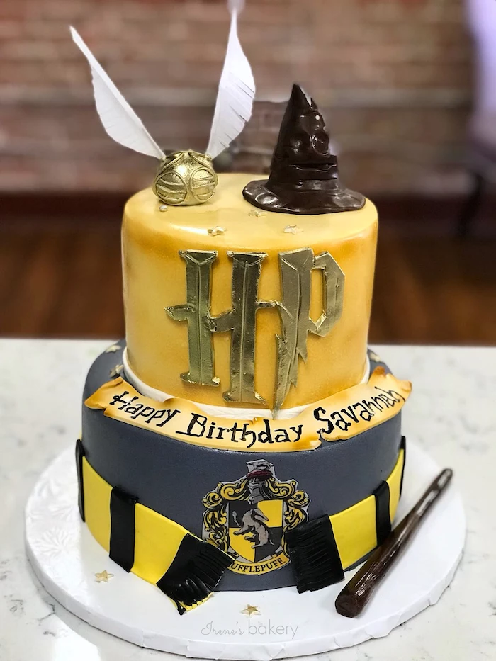 hufflepuff two tier cake, covered with yellow and grey fondant, harry potters birthday cake, black and yellow scarf made of fondant around it