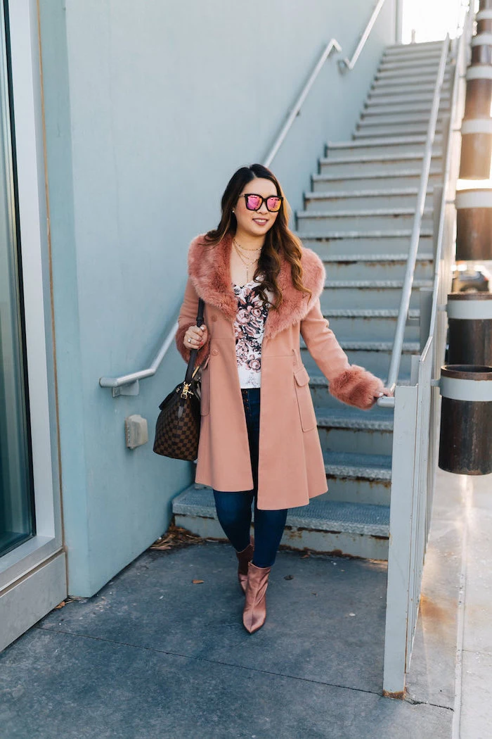 woman wearing jeans, white blouse, long pink coat, pink velvet boots, date outfit ideas, long brown wavy hair