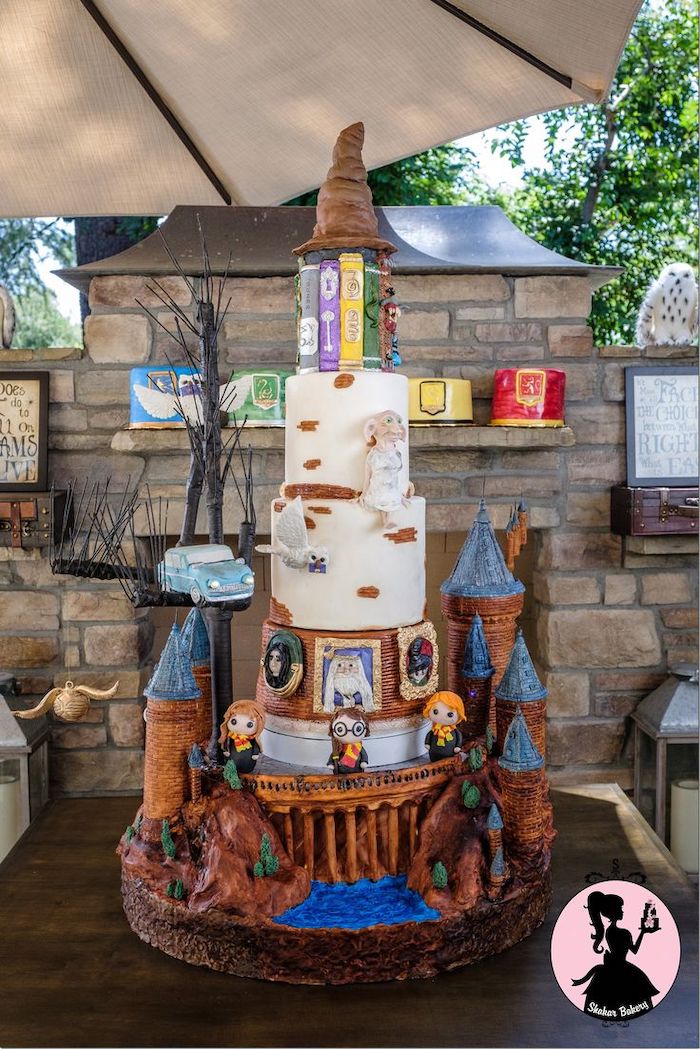 harrys birthday cake, large cake with many layers, hogwarts books and sorting hat on top, harry ron and hermione