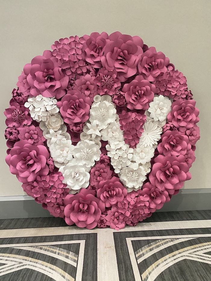 pink paper flowers in different shapes and sizes, paper flower wall decor, letter w made of white paper flowers