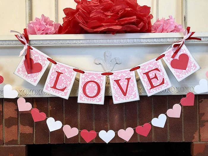 love banner, hearts garland, hanging over mantel, outdoor valentine decorations, large paper flowers on top