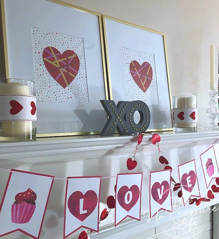 love banner, xo sign with lights, candles and hearts posters, arranged on white mantel, outdoor valentine decorations
