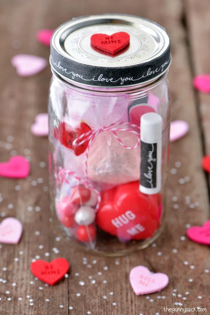 mason jar filled with different things, valentine gift ideas, placed on wooden surface, step by step diy tutorial