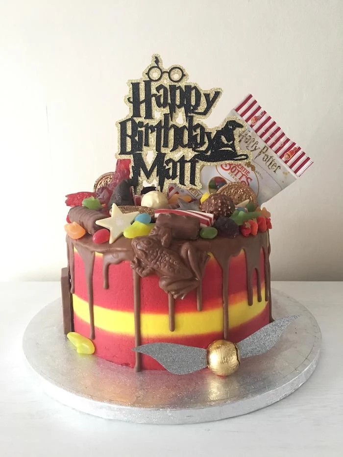 one tier cake made with red and yellow fondant, 11th birthday cake, covered with harry potter inspired candy