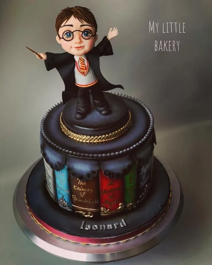 cake layer made up of books, 11th birthday cake, made with fondant, harry potter topper, placed on silver tray