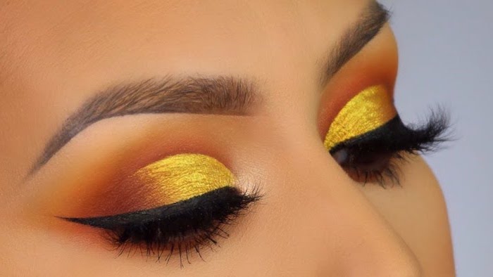 orange and yellow golden eyeshadow colors, how to put on eyeshadow, black cat eyeliner, thing brown eyebrows