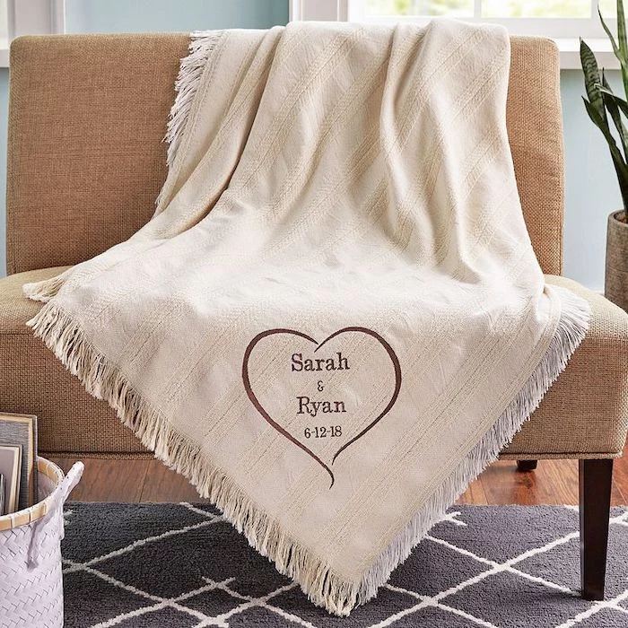 cute valentines day gifts for her, white blanket, thrown over a beige sofa, personalised with sarah and ryan written on it