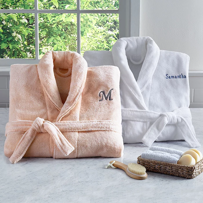 two cozy plush robes, romantic valentines gifts for her, personalised with name and initial, placed on marble surface