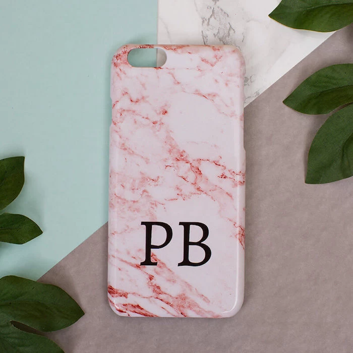 pink marble phone case, romantic valentines gifts for her, personalised with initials, placed on colorful surface