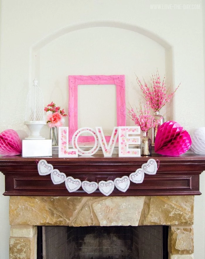 love wooden sign, pink wooden frame, hanging on white wall, valentine lights, hearts garland hanging over mantel