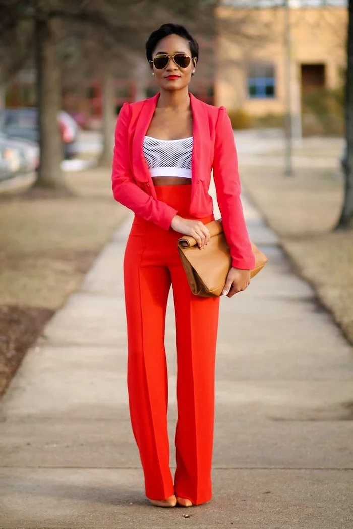 woman walking on the sidewalk, wearing red high waisted pants, red blazer and white crop top, valentine's day clothes