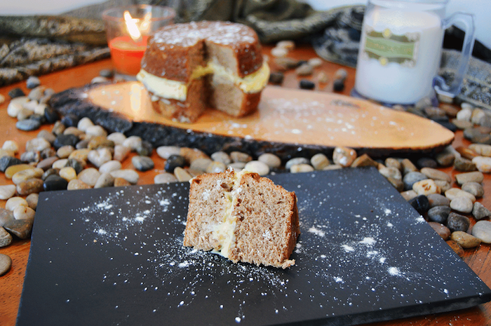 slice of hagrid's rock cake, dusted with powdered sugar, placed on black board, happee birthdae harry, step by step diy tutorial