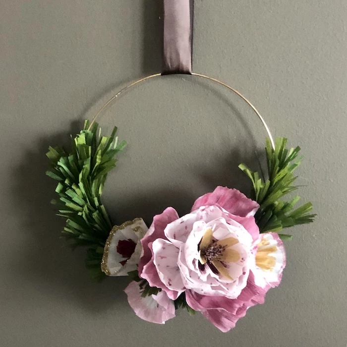 golden ring held by a satin bow, diy tissue paper flowers, wreath made with pink paper flowers and leaves