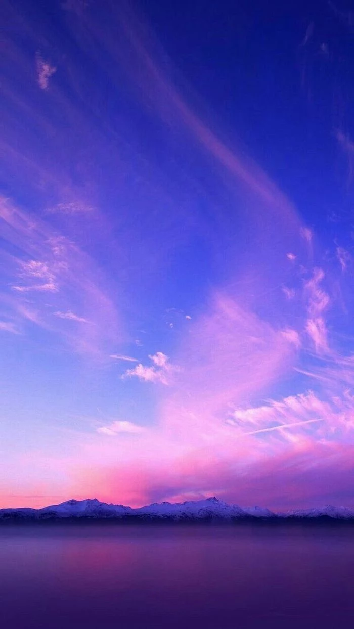 snowy mountain landscape, glass like like at the forefront, aesthetic lockscreen, blue sky with purple pink clouds