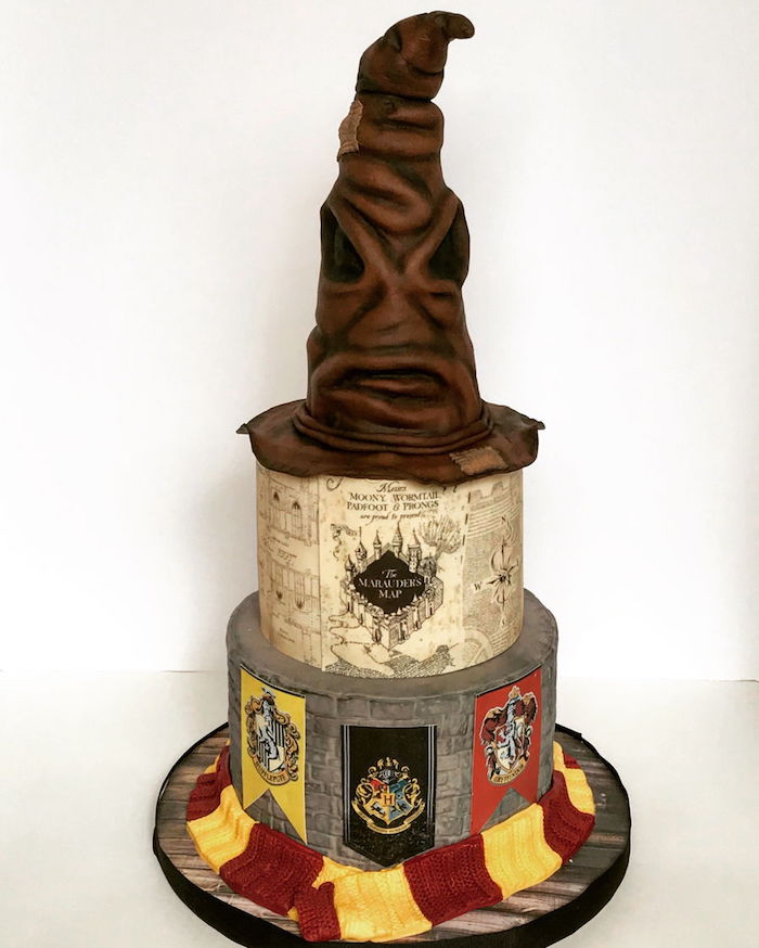 three tier cake, easy harry potter cake, marauder's map on middle tier, sorting hat top tier, gryffindor scarf around it