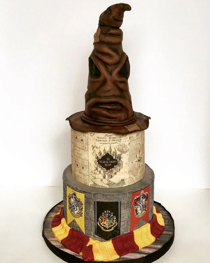 three tier cake, easy harry potter cake, marauder's map on middle tier, sorting hat top tier, gryffindor scarf around it