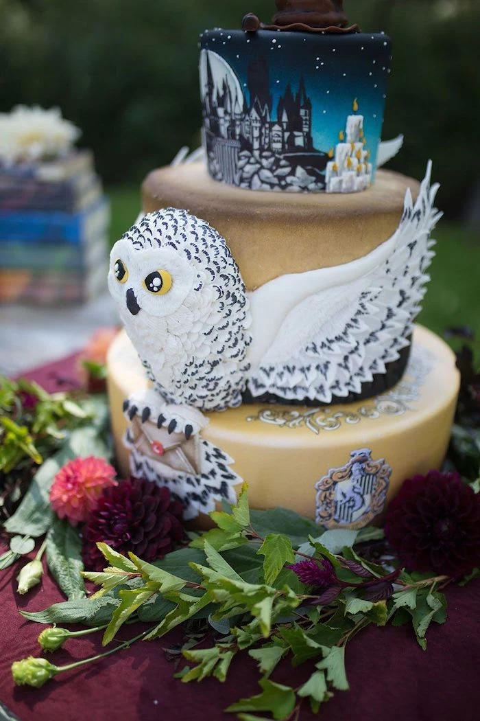 three tier cake with hedwig in the middle, easy harry potter cake, hogwarts painted on the top tier