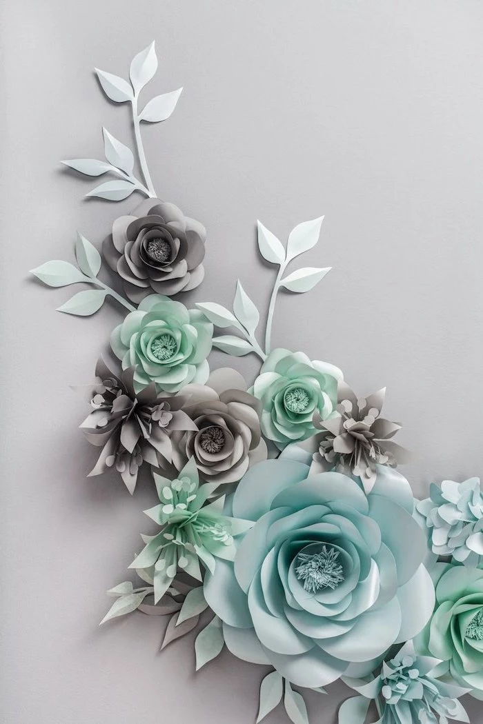 turquoise and grey paper flowers, different shapes and sizes, giant paper flower template, arranged on grey surface