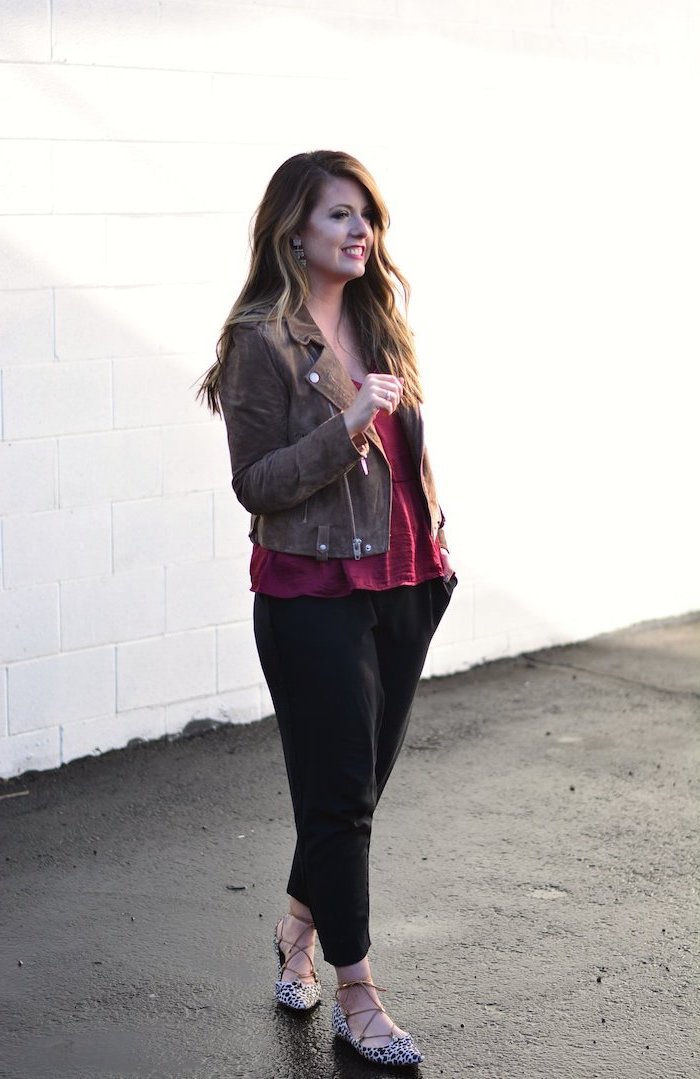 brunette woman wearing red top, black pants and leather jacket, valentines day clothes, leopard print shoes
