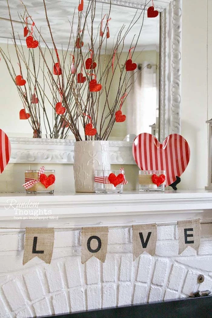 white vase filled with twigs, decorated with red hearts, valentines home decor, love banner over mantel, heart shaped plate