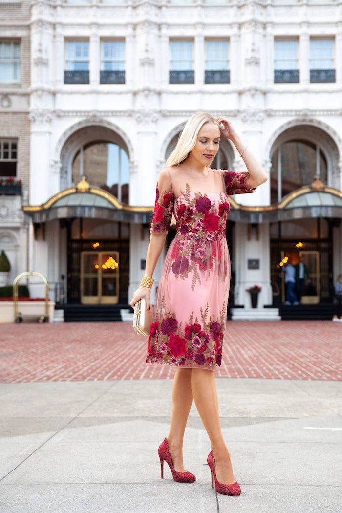 blonde woman wearing pink and red floral dress, valentines day outfit girl, walking on sidewalk, with red heels