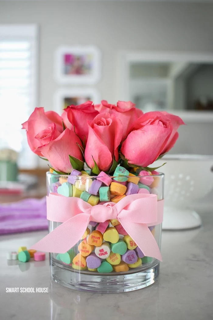 vase filled with conversation hearts, valentines day gifts for her, pink roses inside, wrapped with pink bow