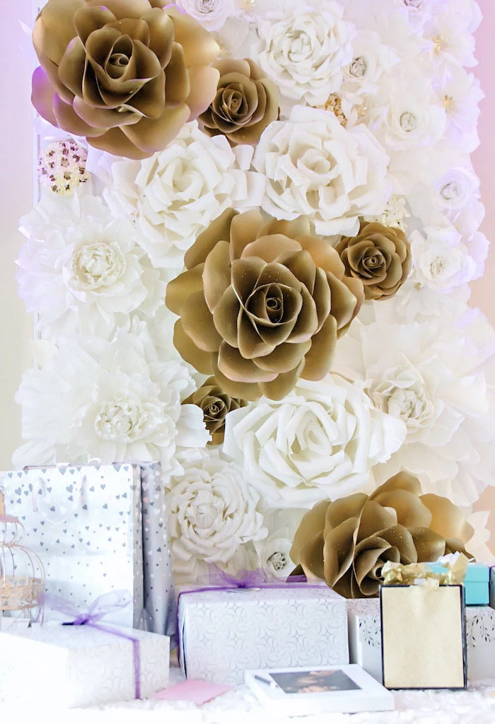 white and gold paper flowers, arranged as backdrop for table full of presents, giant paper flower template
